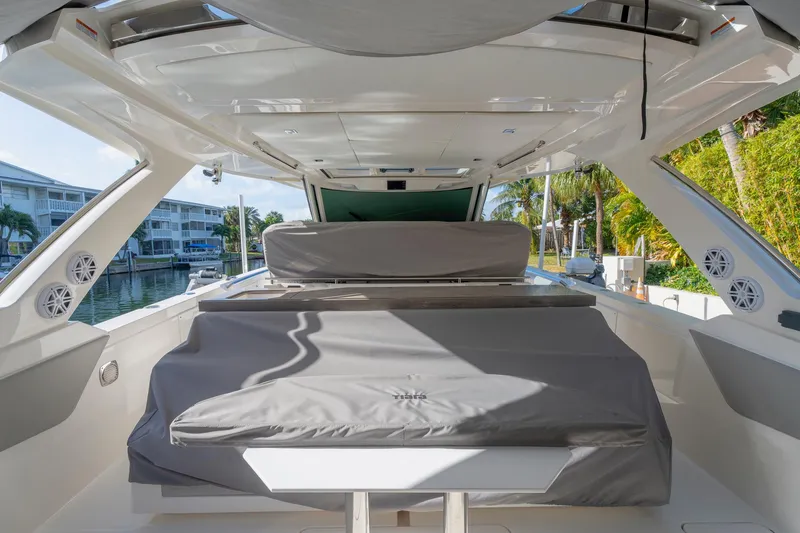 Slide: The Image of 2024 Tiara Yachts 43 LS interior with covered seating and modern design. - 53