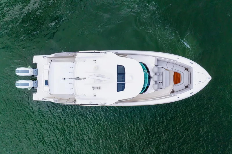 Slide: The Image of Overhead view of 2024 Tiara Yachts 43 LS on water, showcasing sleek design and dual engines. - 58