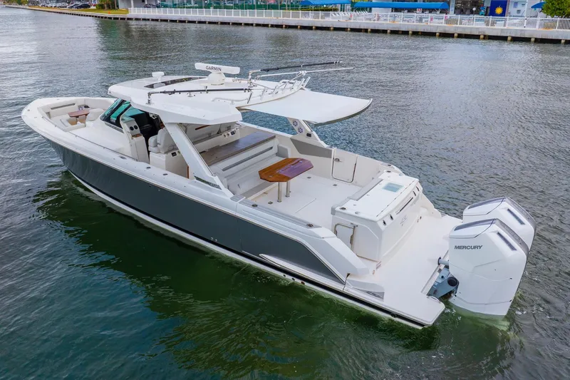 Slide: The Image of 2024 Tiara Yachts 43 LS luxury boat with dual Mercury engines on the water. - 6