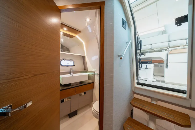 Slide: The Image of Luxurious interior of 2024 Tiara Yachts 43 LS, featuring modern bathroom and sleek wooden finishes. - 8