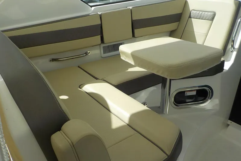 Slide: The Image of 2020 Pursuit OS 355 Offshore boat interior with beige seating and table. - 11