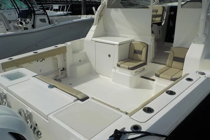 Slide: The Image of 2020 Pursuit OS 355 Offshore boat interior with seating and storage compartments. - 14