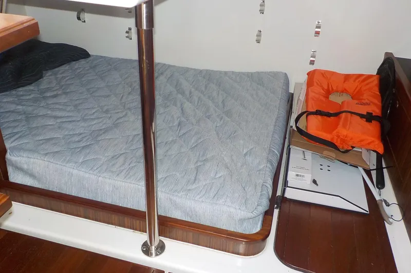Slide: The Image of 2020 Pursuit OS 355 Offshore cabin with bed, life jacket, and wooden flooring. - 21