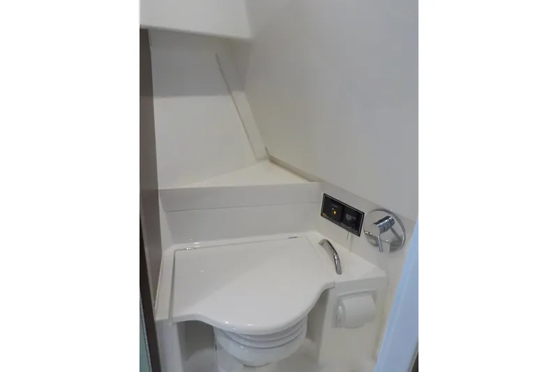 Slide: The Image of 2020 Pursuit OS 355 Offshore boat bathroom with modern toilet and control panel. - 23