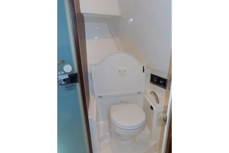 Slide: The Image of 2020 Pursuit OS 355 Offshore boat bathroom with compact toilet and modern fixtures. - 24