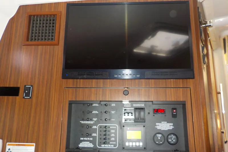 Slide: The Image of Control panel and screen inside 2020 Pursuit OS 355 Offshore boat cabin. - 25