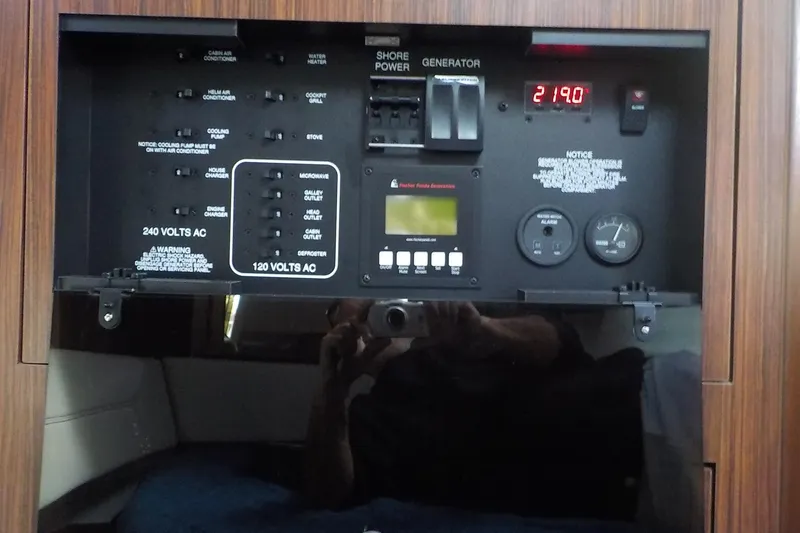 Slide: The Image of Control panel of a 2020 Pursuit OS 355 Offshore boat, featuring power switches and gauges. - 26