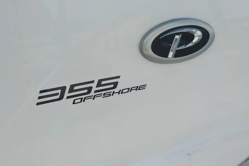 Slide: The Image of 2020 Pursuit OS 355 Offshore boat logo and emblem on white surface. - 3