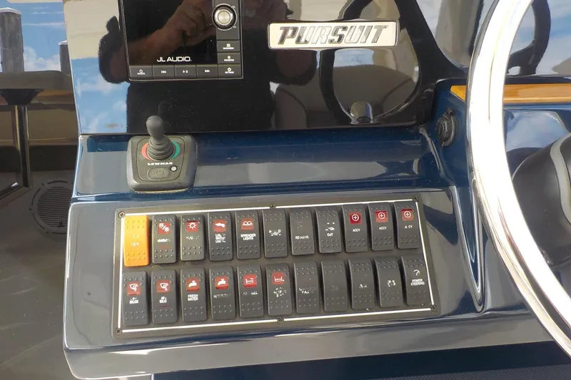 Slide: The Image of Control panel of 2020 Pursuit OS 355 Offshore boat with switches and joystick. - 7