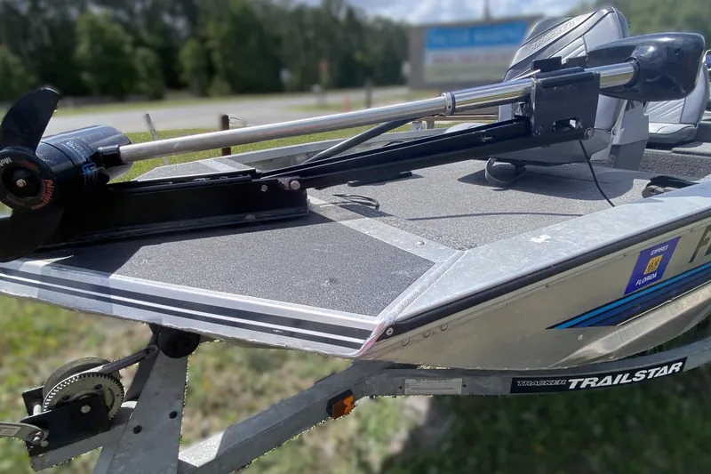 Slide: The Image of 1994 Tracker Pro Guide V-17 SC boat on trailer with trolling motor, parked outdoors. - 6