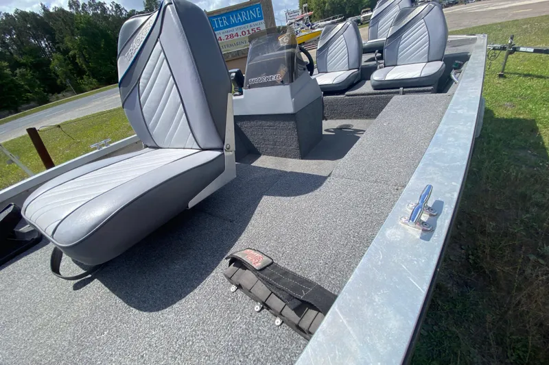 Slide: The Image of 1994 Tracker Pro Guide V-17 SC boat interior with gray seating and steering console. - 8