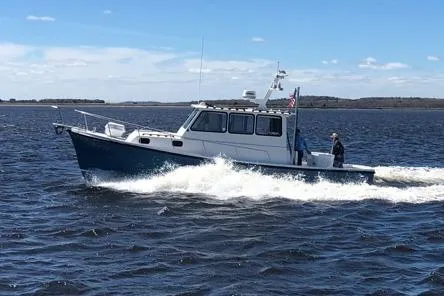The Image of Eastern 35 Casco Bay boat cruising on water, 1998 model, under clear blue sky. - 0
