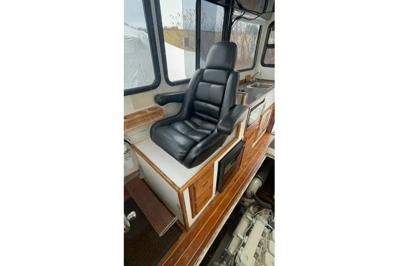 Slide: The Image of Interior of a 1998 Eastern 35 Casco Bay boat with a black captain's chair. - 10