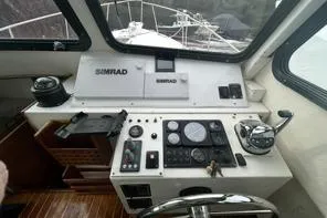Slide: The Image of 1998 Eastern 35 Casco Bay boat cockpit with navigation instruments and steering wheel. - 11