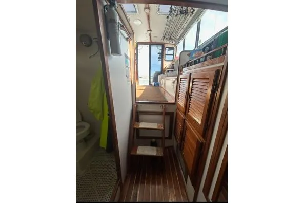 Slide: The Image of Interior view of 1998 Eastern 35 Casco Bay boat with wooden finishes and compact layout. - 12