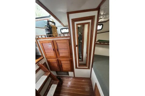 Slide: The Image of Interior of 1998 Eastern 35 Casco Bay boat with wooden cabinetry and mirror. - 13