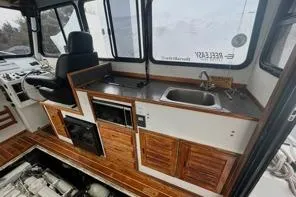 Slide: The Image of Interior of 1998 Eastern 35 Casco Bay boat with kitchenette and seating. - 15