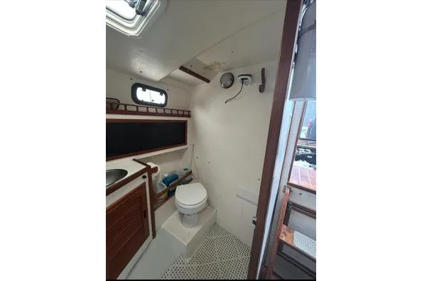Slide: The Image of 1998 Eastern 35 Casco Bay boat bathroom with toilet, sink, and storage. - 16