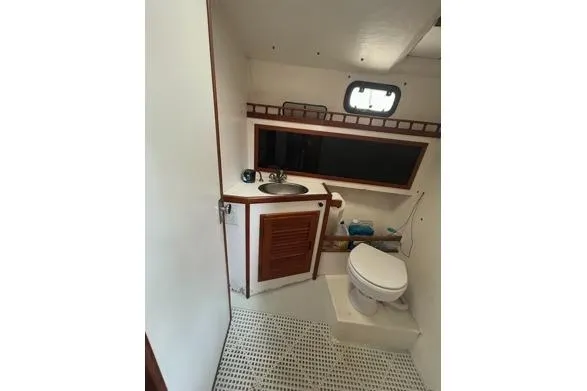 Slide: The Image of 1998 Eastern 35 Casco Bay boat bathroom with sink, toilet, and window. - 17