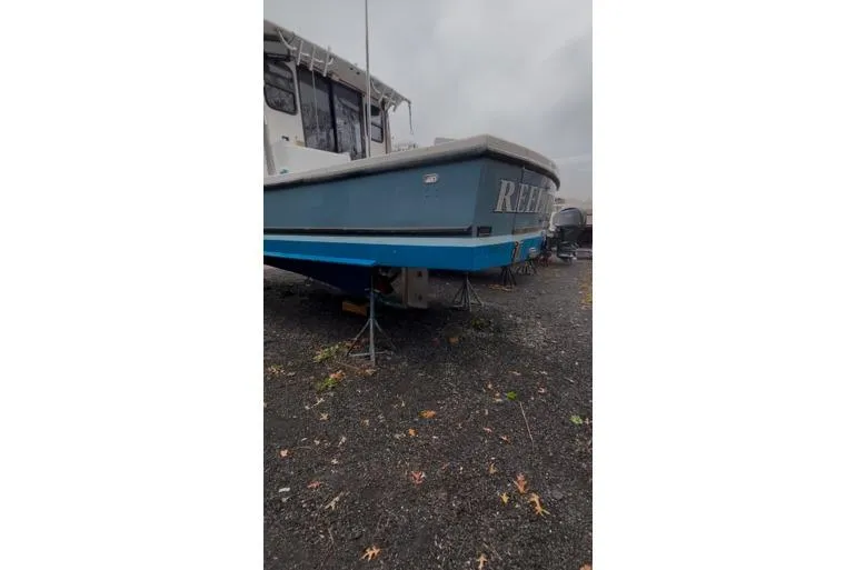 Slide: The Image of 1998 Eastern 35 Casco Bay boat on stands, displayed outdoors on gravel. - 19