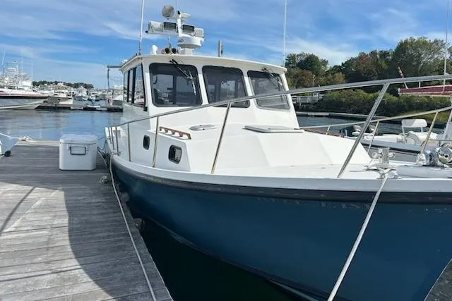 Slide: The Image of 1998 Eastern 35 Casco Bay boat docked at marina under clear blue sky. - 2