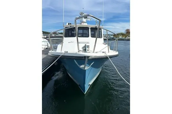 Slide: The Image of 1998 Eastern 35 Casco Bay boat docked on calm water under blue sky. - 4