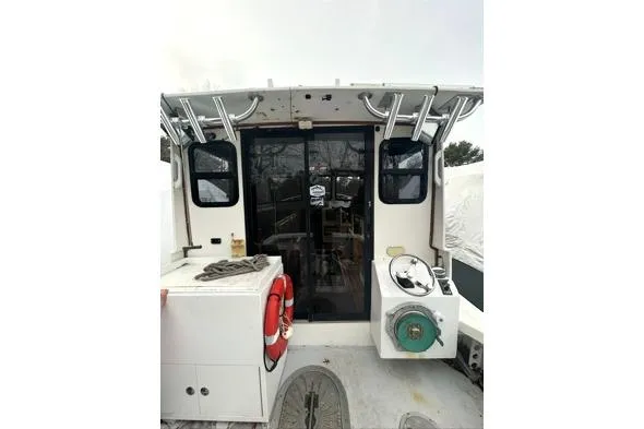 Slide: The Image of 1998 Eastern 35 Casco Bay boat with enclosed cabin and deck equipment. - 7