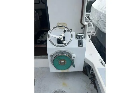 Slide: The Image of Steering wheel and controls of a 1998 Eastern 35 Casco Bay boat. - 8