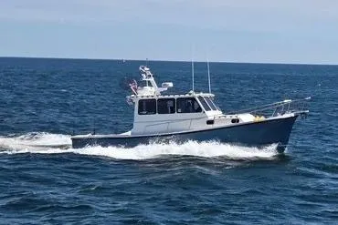 Slide: The Image of 1998 Eastern 35 Casco Bay boat cruising on open water. - 3