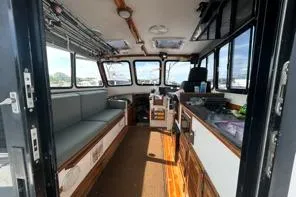 Slide: The Image of Interior of 1998 Eastern 35 Casco Bay boat with seating and windows. - 9
