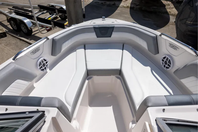 Slide: The Image of 2021 Chaparral 21 SSi OB boat interior with white seating and speakers. - 10