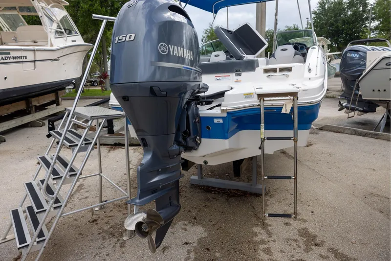 Slide: The Image of 2021 Chaparral 21 SSi OB boat with Yamaha 150 outboard motor, docked with access ladder. - 3
