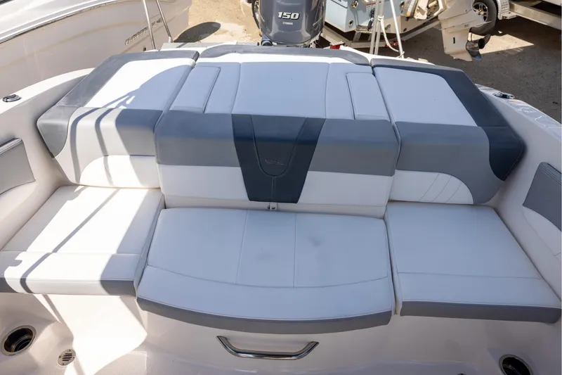 Slide: The Image of 2021 Chaparral 21 SSi OB boat with cushioned seating and Yamaha 150 outboard motor. - 5