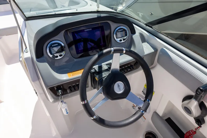 Slide: The Image of 2021 Chaparral 21 SSi OB boat dashboard with steering wheel and digital display. - 7
