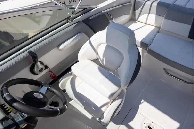 Slide: The Image of Interior of 2021 Chaparral 21 SSi OB boat with white seating and steering wheel. - 8