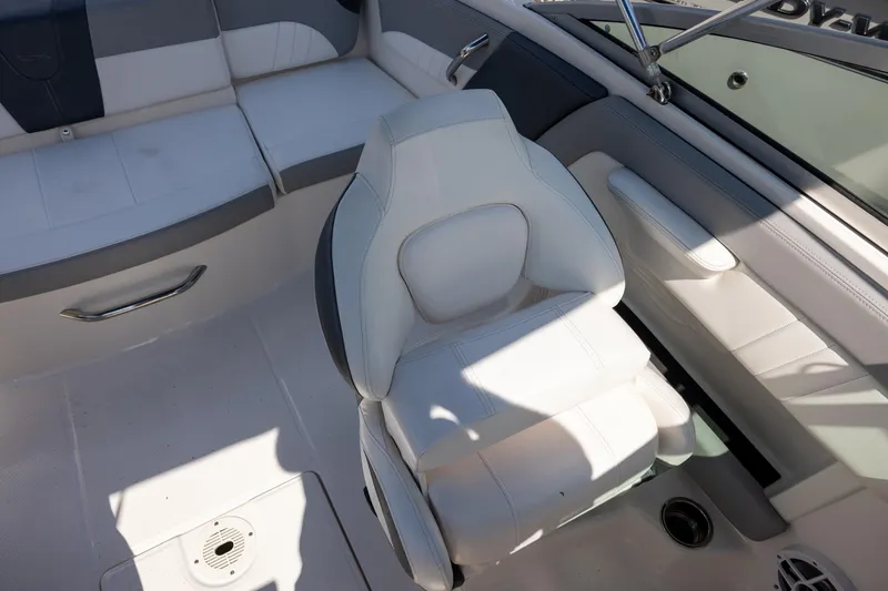 Slide: The Image of 2021 Chaparral 21 SSi OB boat interior with white seating and modern design. - 9
