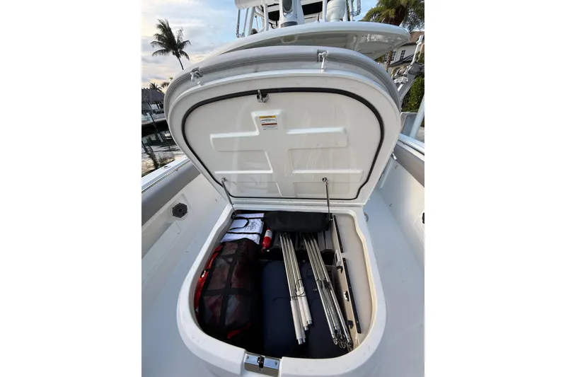 Slide: The Image of Open storage compartment on 2023 Boston Whaler 380 Outrage boat, containing gear and equipment. - 12