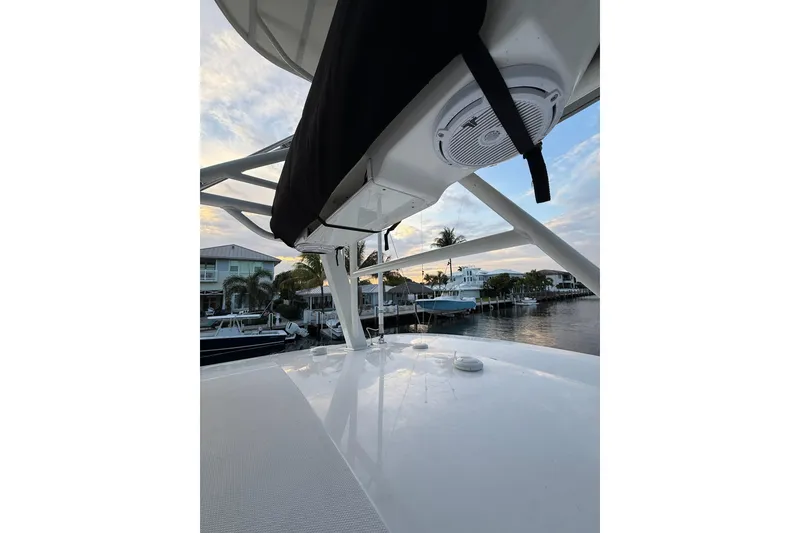 Slide: The Image of 2023 Boston Whaler 380 Outrage boat deck with speaker, docked at sunset. - 13