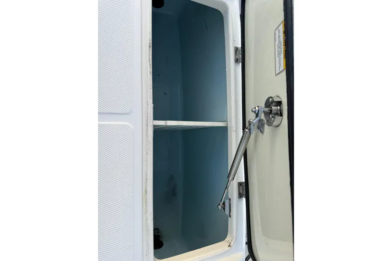 Slide: The Image of Storage compartment of 2023 Boston Whaler 380 Outrage boat, open with hydraulic support. - 16