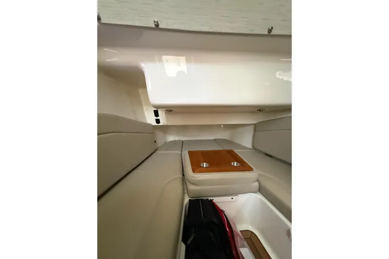 Slide: The Image of Interior cabin of 2023 Boston Whaler 380 Outrage with cushioned seating and wooden table. - 18
