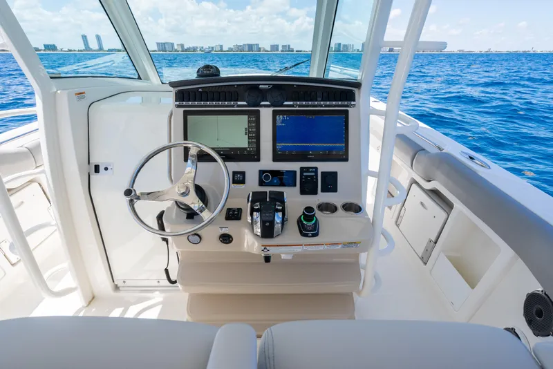 Slide: The Image of 2020 Boston Whaler 380 Outrage helm with advanced navigation system on open sea. - 25