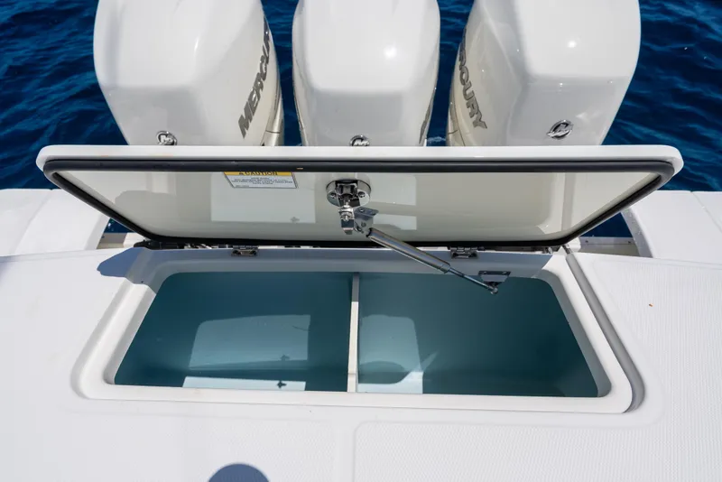 Slide: The Image of Open storage compartment on 2020 Boston Whaler 380 Outrage boat with Mercury engines. - 28