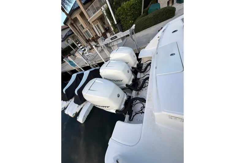 Slide: The Image of 2023 Boston Whaler 380 Outrage with triple Mercury outboard engines docked. - 3