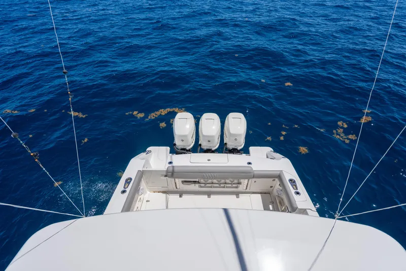 Slide: The Image of Boston Whaler 380 Outrage 2020 boat with triple engines on open sea. - 31