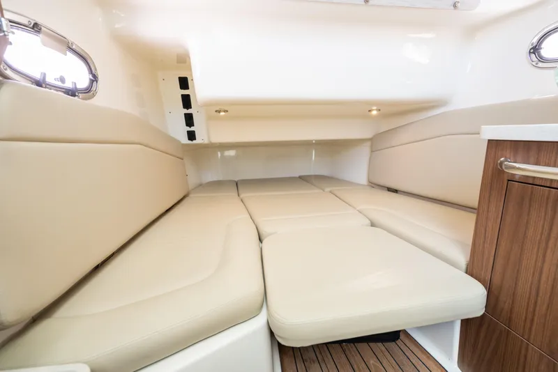 Slide: The Image of 2020 Boston Whaler 380 Outrage cabin interior with beige seating and wood accents. - 34