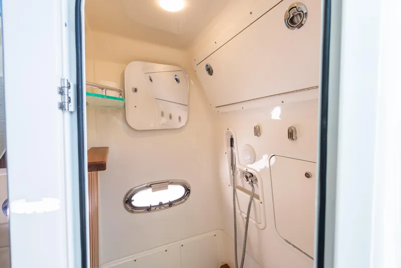 Slide: The Image of 2020 Boston Whaler 380 Outrage cabin interior with shower and storage compartments. - 37
