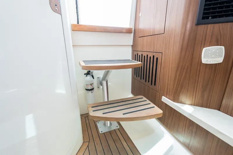 Slide: The Image of Interior of 2020 Boston Whaler 380 Outrage, featuring wooden steps and modern design elements. - 40