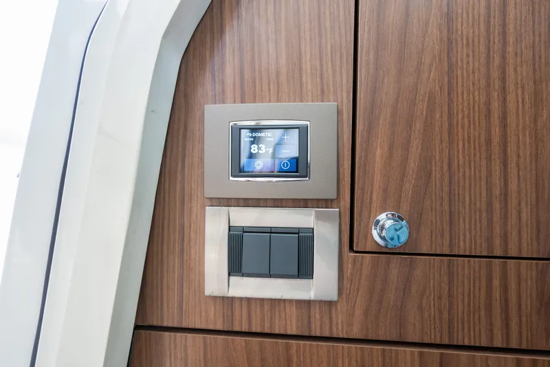Slide: The Image of 2020 Boston Whaler 380 Outrage interior with wood paneling and digital control display. - 43