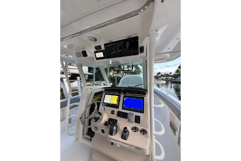 Slide: The Image of 2023 Boston Whaler 380 Outrage helm with advanced navigation displays and controls. - 6