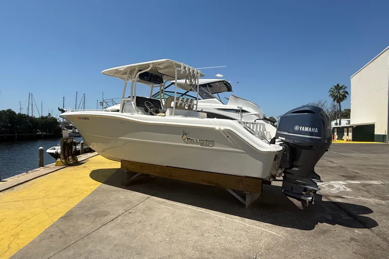 Slide: The Image of 2019 Key West Billistic 281 Center Console boat with Yamaha engine on dock. - 1